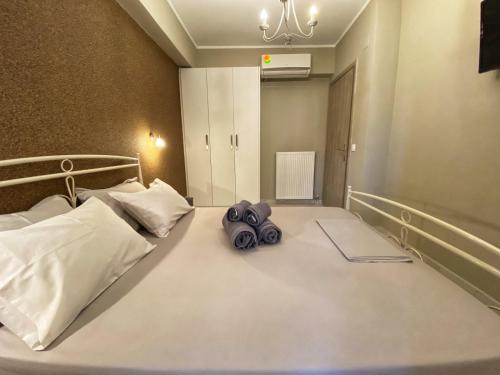 a bedroom with a bed with a pair of shoes on it at Joanna's apartments in Virós