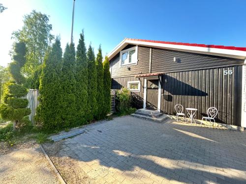 a house with a driveway and a building at Villa Anastazja in Vendelsö