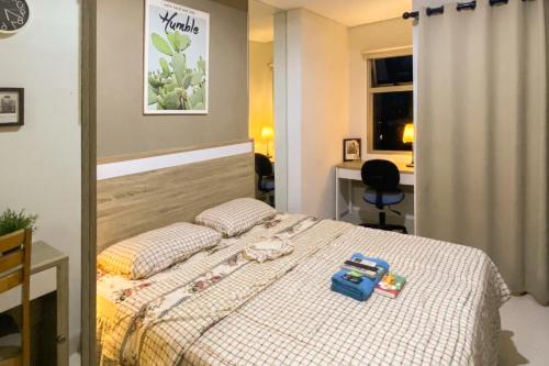 a bedroom with a bed with toys on it at RedLiving Springwood Residence - Living space in Warungmangga