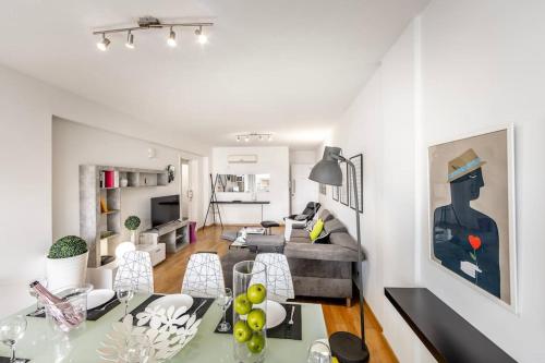 a living room with a table and a couch at Luxurious Bright & Stylish 2BR with Office in Nicosia in Nicosia