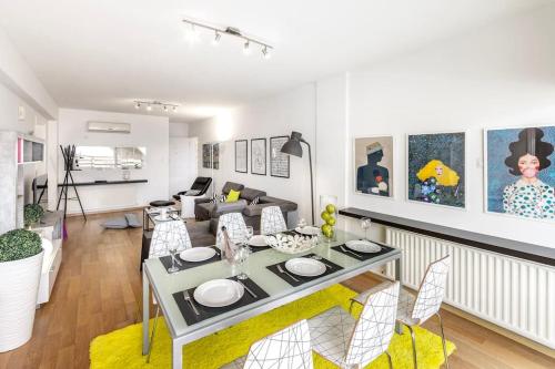 a living room with a table and a couch at Luxurious Bright & Stylish 2BR with Office in Nicosia in Nicosia