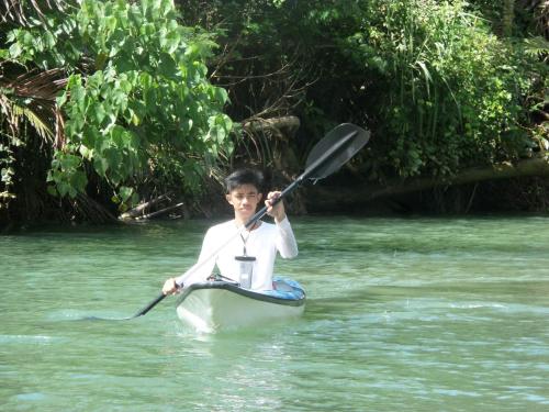 a young boy is in a kayak in the water at Rose Cabins Bohol in Loon