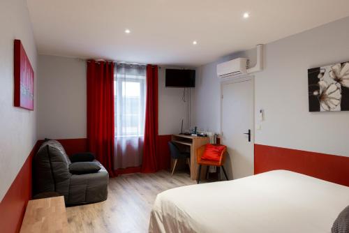 a bedroom with a bed and a chair and a desk at Logis Hotel-Restaurant Saint Romain in Anse