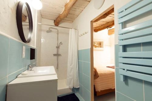 une salle de bain avec un lavabo, une douche et un miroir dans l'établissement Studio provençal au cœur de la Sainte-Victoire, à Puyloubier