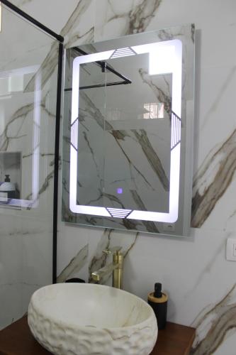 a bathroom with a sink and a mirror at Vila D in Berat