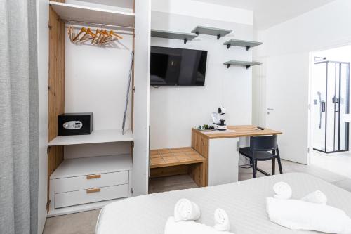 a bedroom with a bed and a desk and a table at Gallo's City Rooms in Termoli