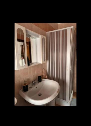 un bagno con un lavandino bianco e uno specchio di RESIDENZA LAURIOLA a Rodi Garganico