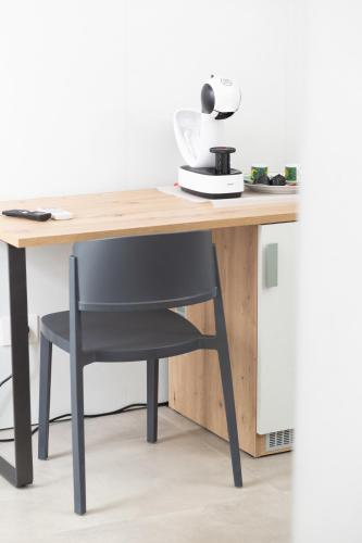 a wooden desk with a black chair next to it at Gallo's City Rooms in Termoli