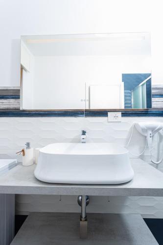 a white sink on a counter in a bathroom at Gallo's City Rooms in Termoli