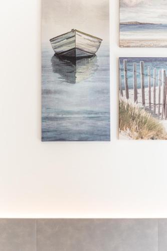 a painting of a boat in the water at Gallo's City Rooms in Termoli