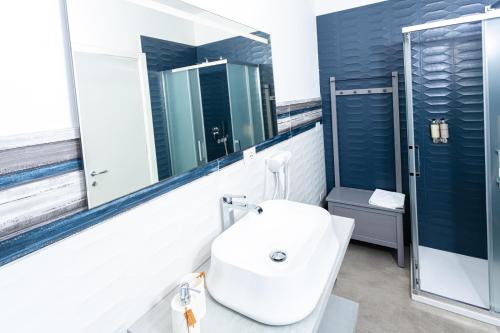 a bathroom with a sink and a mirror at Gallo's City Rooms in Termoli