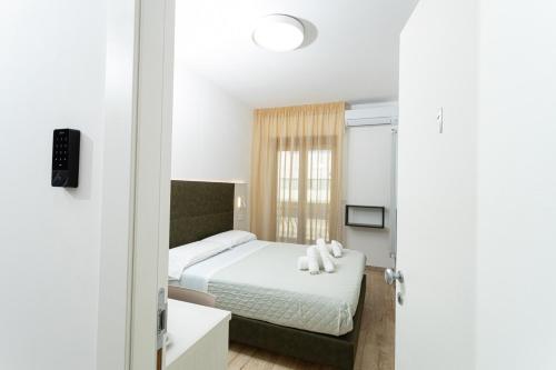 a small bedroom with a bed and a window at Gallo's City Rooms in Termoli