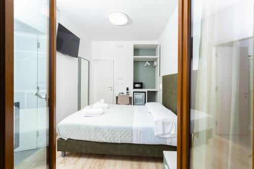 a bedroom with a bed and a sliding glass door at Gallo's City Rooms in Termoli