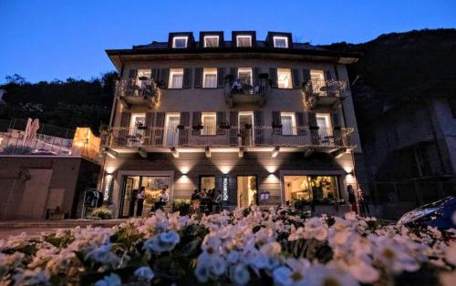 a building with a lot of flowers in front of it at LUXURY SUITES ROCOPOM - Lake Front in Lecco