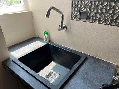 a kitchen sink with a faucet above it at NIRMAN HOMESTAY 5 minutes walk to beach in Puri