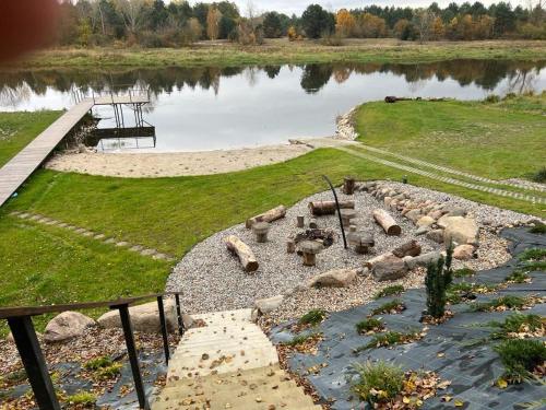 a rock garden with a pond and a bridge at Relax nad Narwią u Oli I Pawła in Pultusk