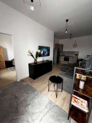 a living room with a black chair and a television at Relax nad Narwią u Oli I Pawła in Pultusk