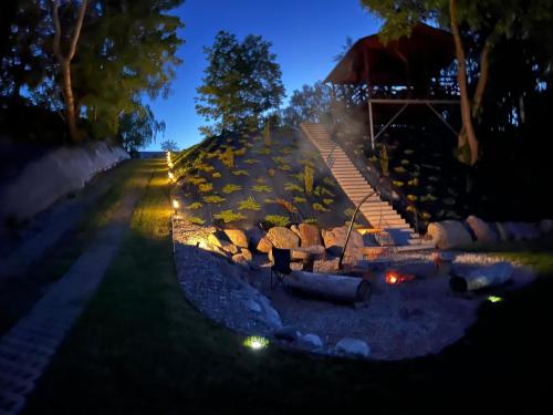 a set of stairs leading up to a house at night at Relax nad Narwią u Oli I Pawła in Pultusk