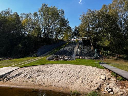 a view of a park with a hill and a bridge at Relax nad Narwią u Oli I Pawła in Pultusk