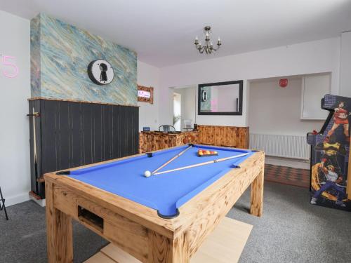 a ping pong table in a room with a pool at The Old Station House in Withernsea