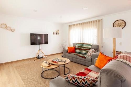 a living room with a couch and a table at Casa das Hortênsias in Cerdeira