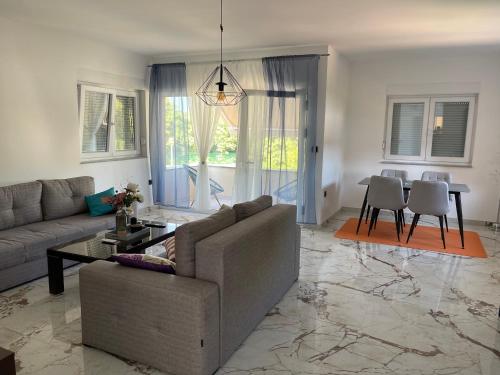 a living room with a couch and a table at Apartment Vila Tara in Bihać