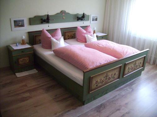 a bedroom with a large bed with pink pillows at Haus-Becker-Schmidt-St-Blasien in St. Blasien