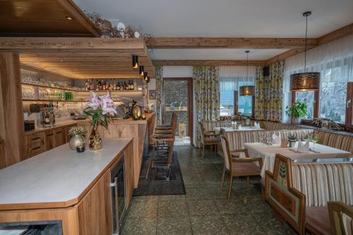 ハイリゲンブルートにあるペンション トロヤホーフのテーブルと椅子のあるレストラン、バー