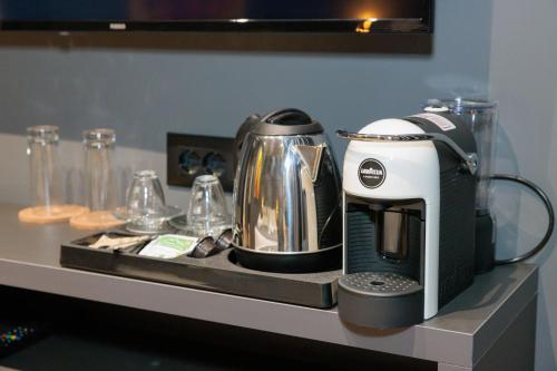 a coffeemaker sitting on a counter with a coffee maker at Bel Ami Tirana in Tirana