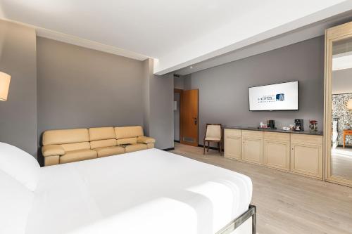 a bedroom with a bed and a flat screen tv at City Style Hotel Reggio Emilia in Reggio Emilia