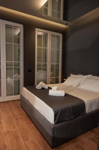 a bedroom with a large bed with two towels on it at Bel Ami Tirana in Tirana