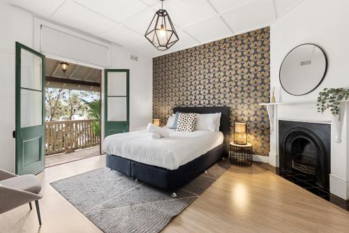 a bedroom with a bed and a fireplace at Perfect Holiday Home with Private Rooftop in Sydney
