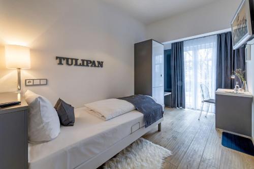 a bedroom with a bed in a room with a window at Designhotel 1690 & Apartments in Rendsburg