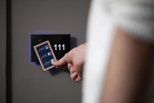 a person holding up a lightswitch with their hand at City Style Hotel Reggio Emilia in Reggio Emilia