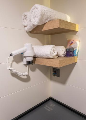 a bathroom with a towel dispenser on a wall at Efe Tiny House in Serik