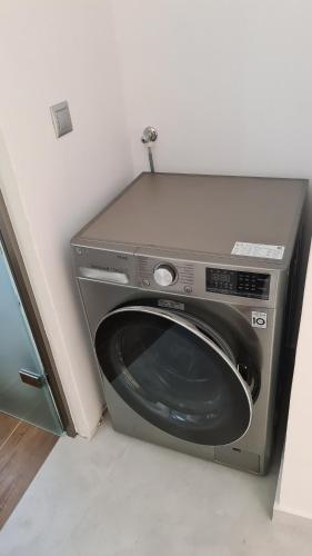 a washing machine is sitting in a room at Aegean Sunset in Agios Sostis