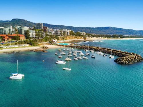 an aerial view of a harbor with boats in the water at Marlo's Escape - A Generous Haven for Couples in Wollongong
