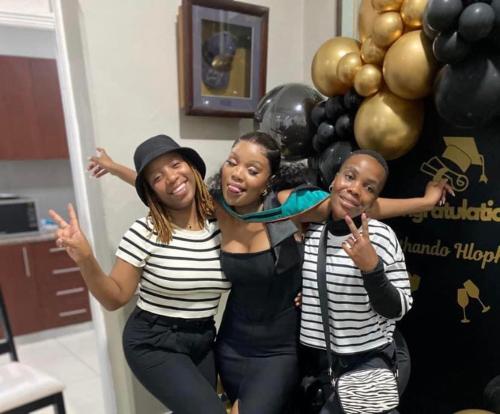 three girls posing for a picture in front of balloons at Henwood House in Durban