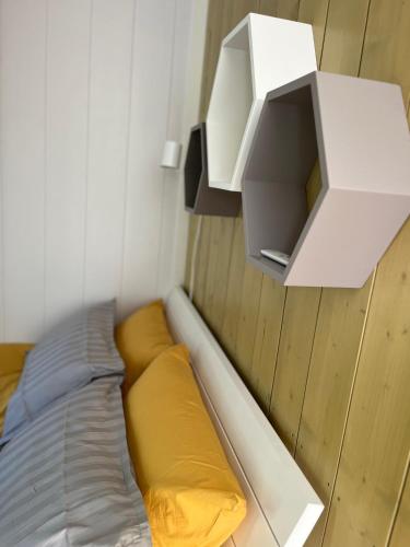 a small bedroom with a bed and a white wall at Mesipesa Yellow Lodge in Meriküla