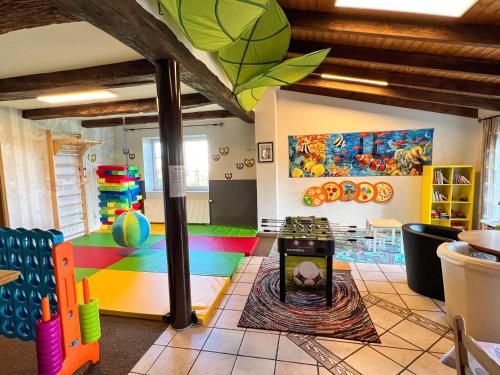 a room with a playroom with a colorful floor at Ferienhof Wübbold - Lavendel in Rieste