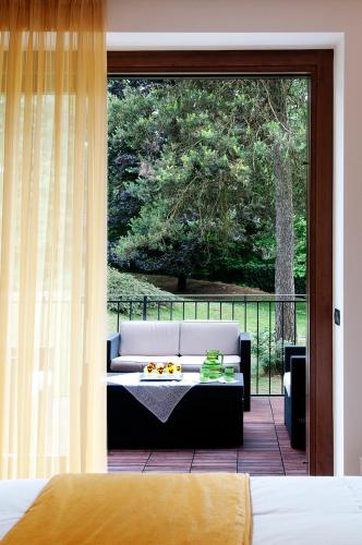 a living room with a couch and a patio at Bed&Garden in Cesate