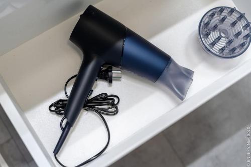 a hair dryer sitting on a white shelf at Petite Dinant - Feet in water hands on the rock in Dinant