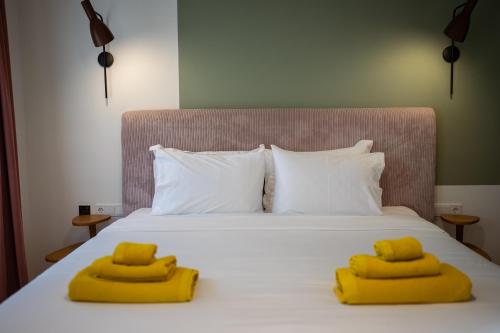 a bed with two yellow pillows on top of it at Bugan-Villa in Athens