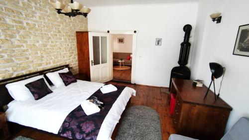 a bedroom with a bed and a brick wall at Casa Romana in Turda