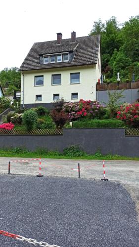 a large white house with a lot of flowers at Ferienwohnung mit Terrassen für 1-4 Personen in Altena