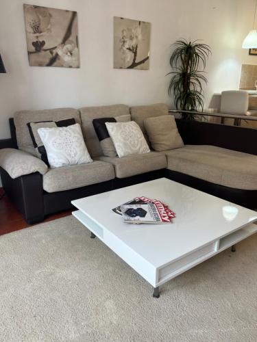 a living room with a couch and a white coffee table at Apto La Manzana del Gaitero in Villaviciosa