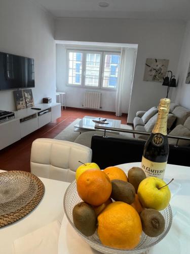 a bowl of fruit on a table in a living room at Apto La Manzana del Gaitero in Villaviciosa