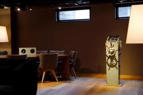 a room with a table with chairs and a heater at HakoBA Hakodate by THE SHARE HOTELS in Hakodate