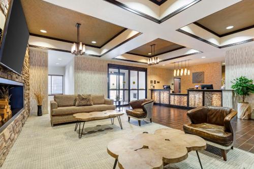 a living room with couches and a table at Comfort Inn & Suites Brighton Denver NE Medical Center in Brighton