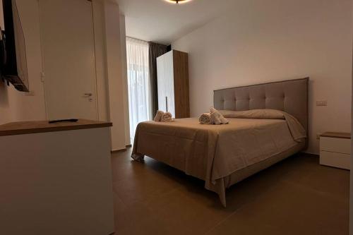 a bedroom with a bed with two towels on it at CconfortHotels Puglia Promenade Apartment 3 in Bari